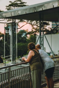 A man and woman look out over an outdoor stage
